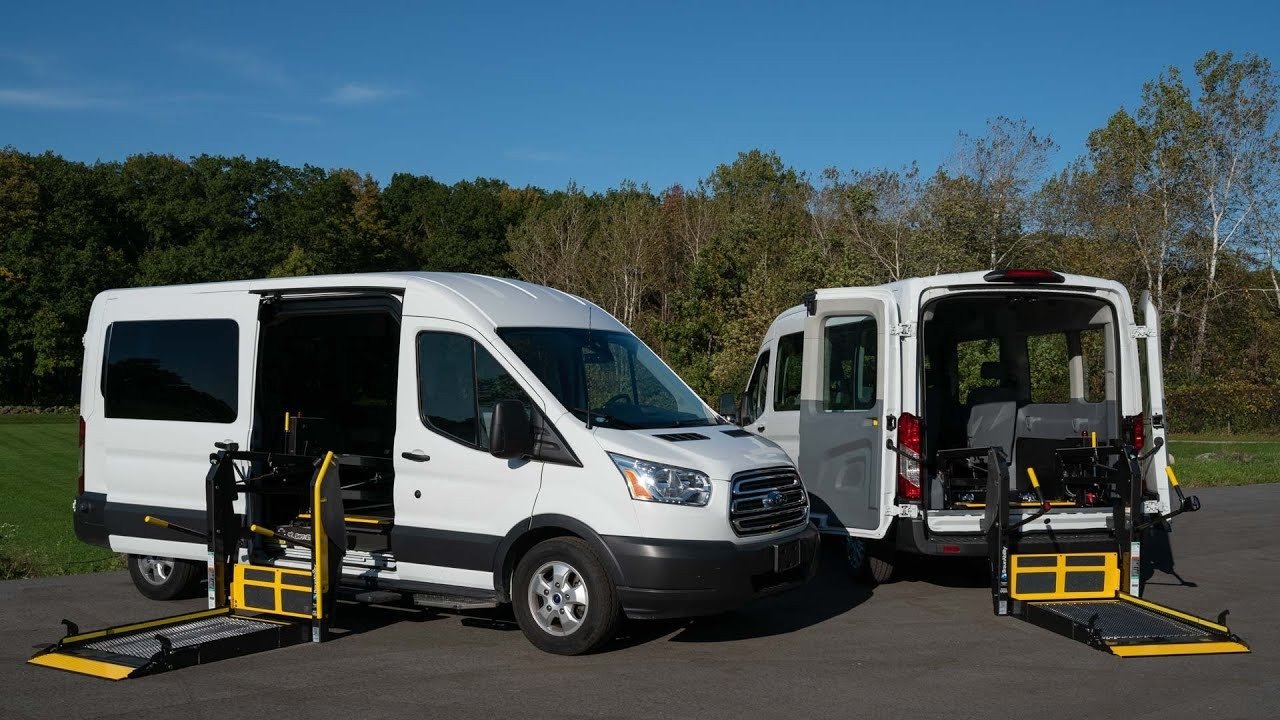 Two Ford E-Transit accessible vans with wheelchair lifts deployed
